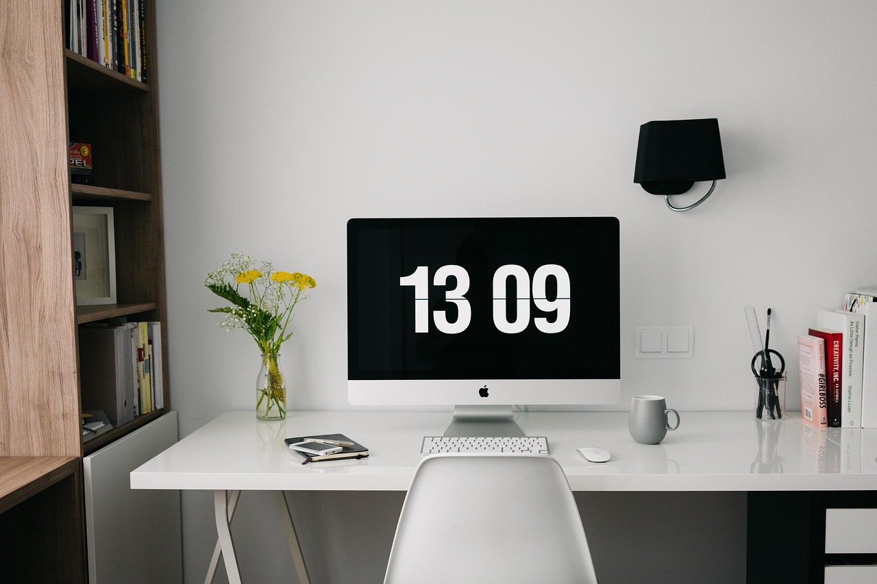 Bright desk workspace with laptop and notebooks arranged for focused planning